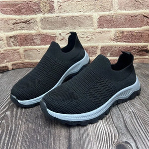 Black knit slip-on sneakers with platform sole and sock-fit design.