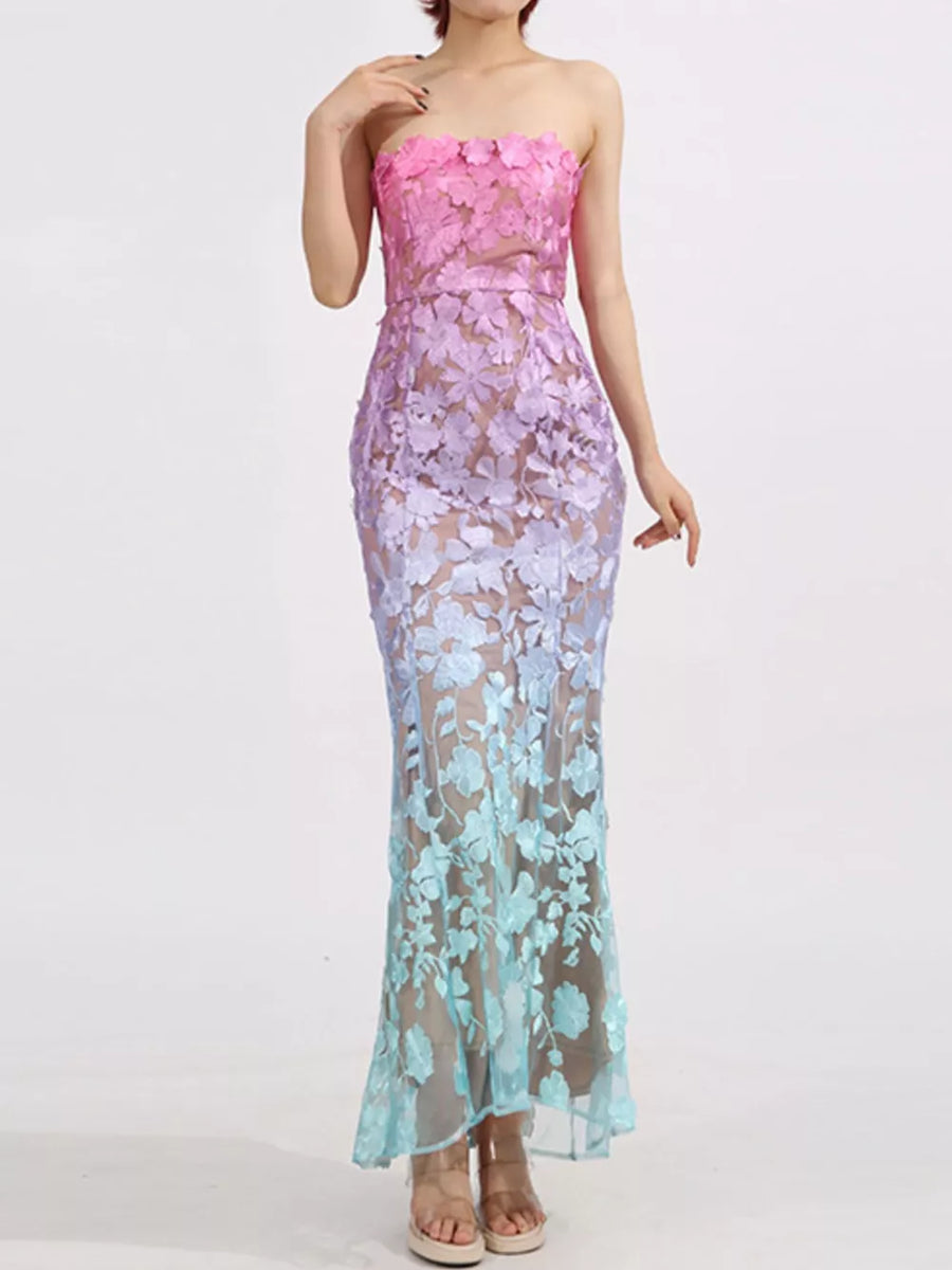 Strapless maxi dress in sheer floral lace with pink to blue ombre gradient.
