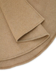 Tan cape coat detail showing hem and fabric texture