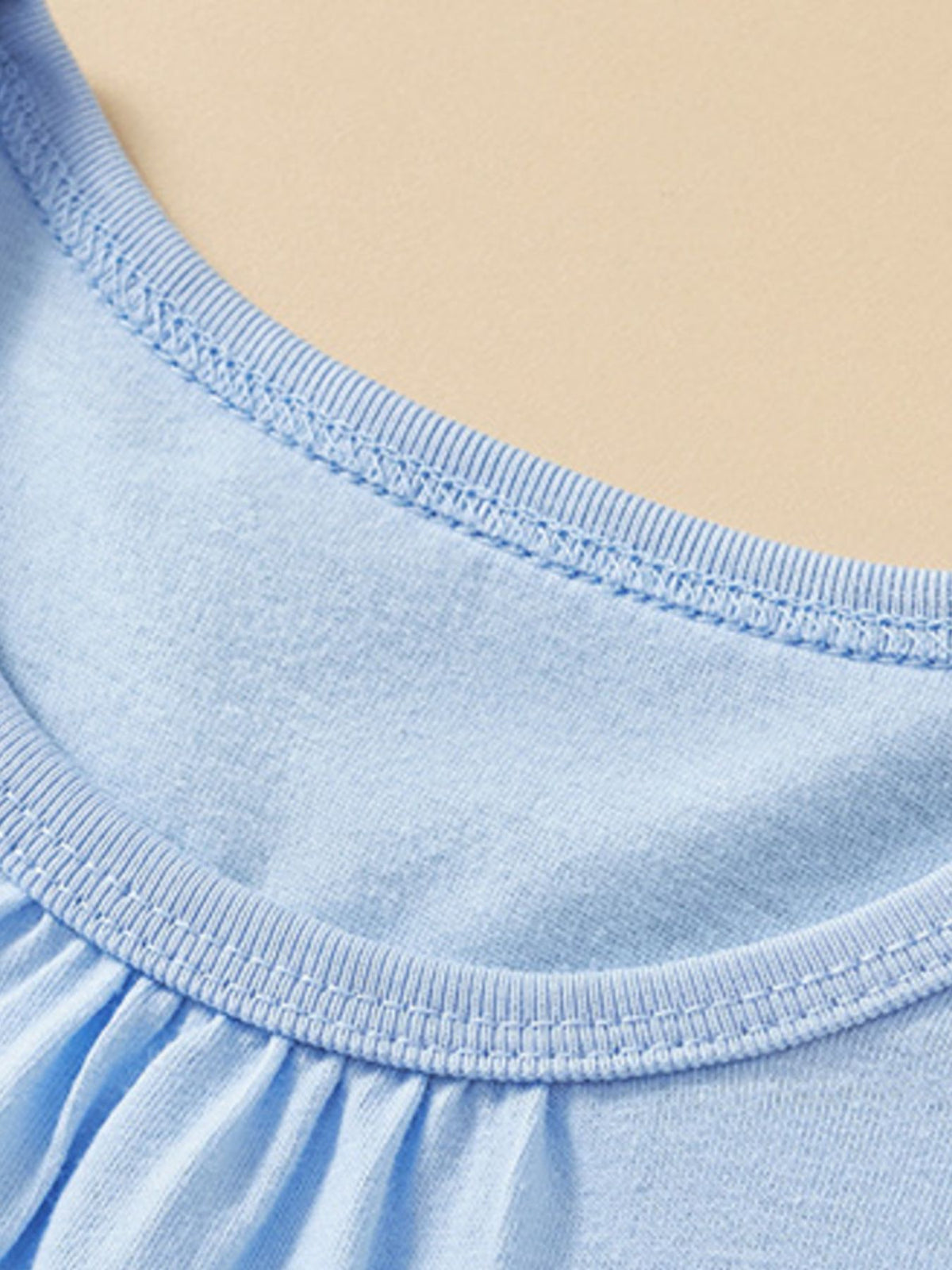 Light blue cotton toddler t-shirt with crew neck and ruffled detail.
