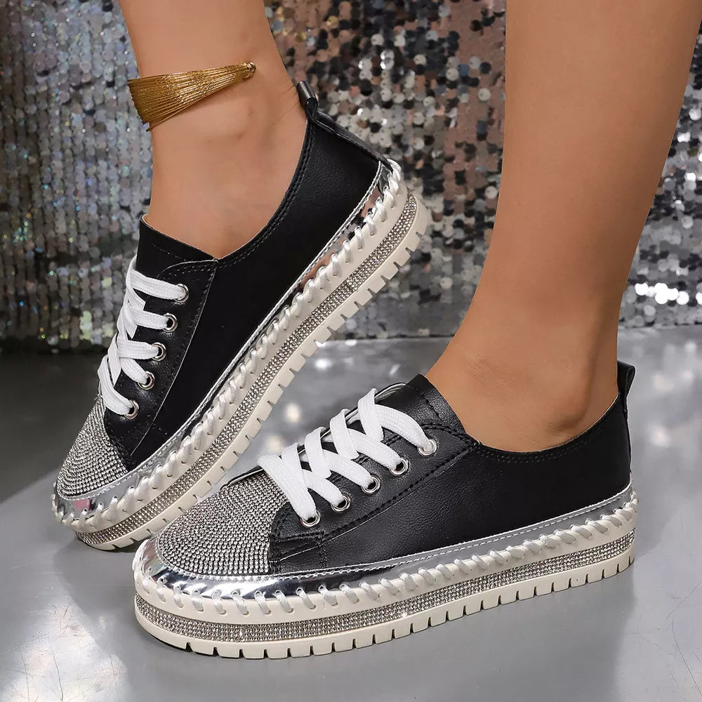 Black sneakers with rhinestone toe and chunky sole, featuring silver accents.