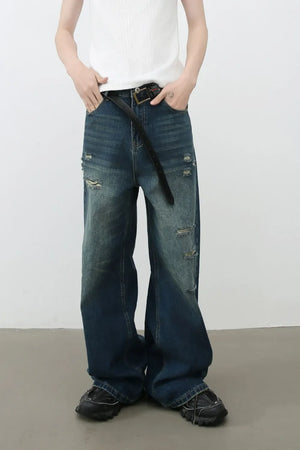 Distressed baggy denim jeans in dark wash with ripped details.