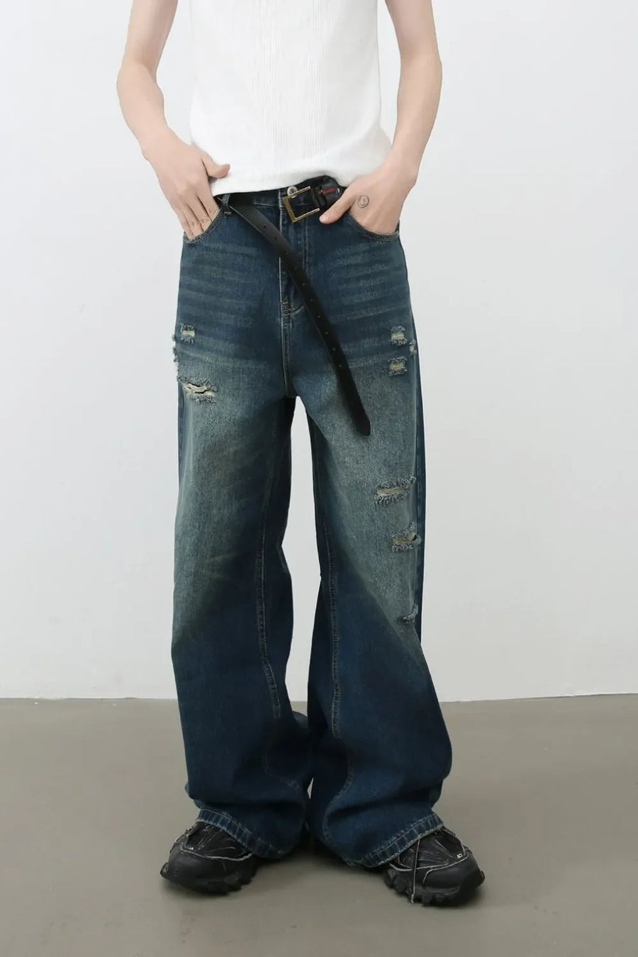 Distressed baggy denim jeans in dark wash with ripped details.
