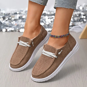 Taupe linen-blend boat shoes with white laces and contrast sole.