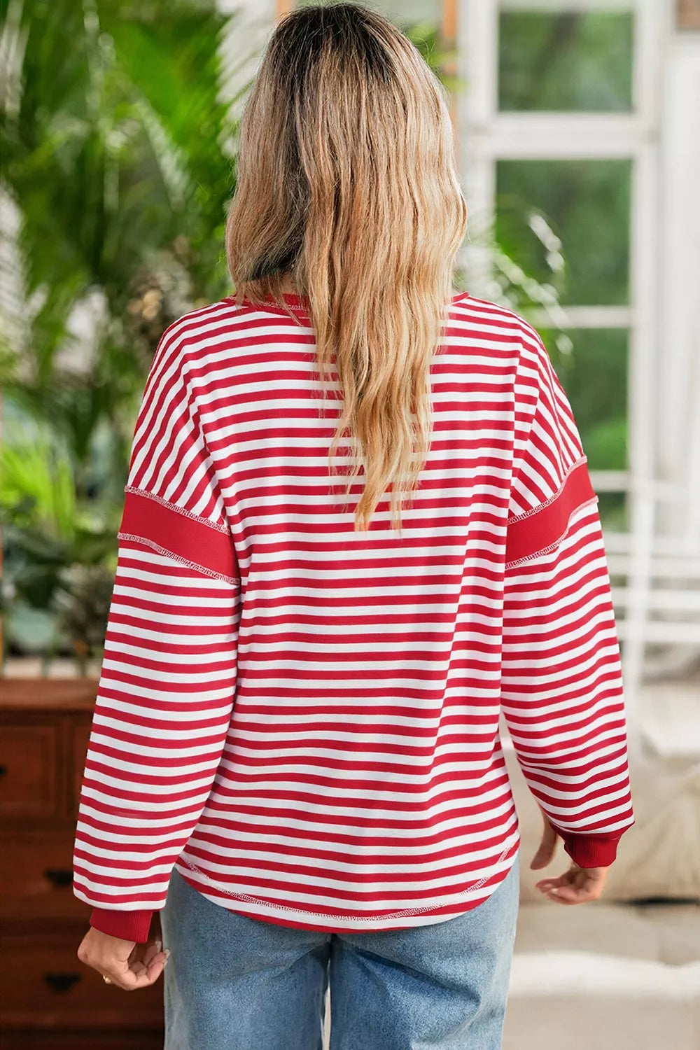 white sweatshirt featuring contrast stitching and striped