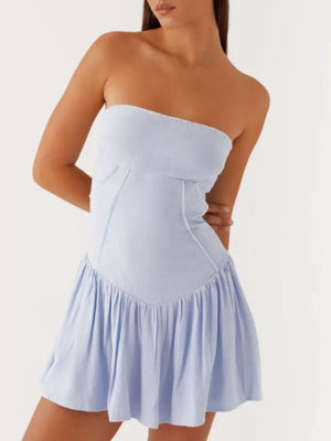 Light blue ruffled tube dress with seamed bodice and tiered skirt.