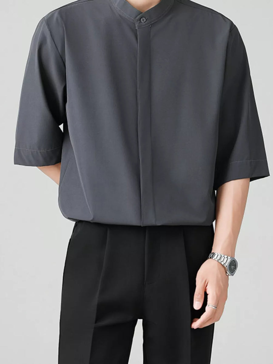 Dark gray oversized mandarin collar half-sleeve shirt with button-down front.