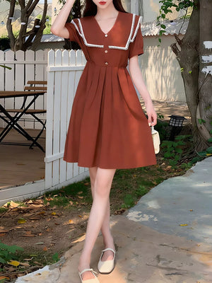 Brown short sleeve dress with lace-trimmed sailor collar and decorative buttons.