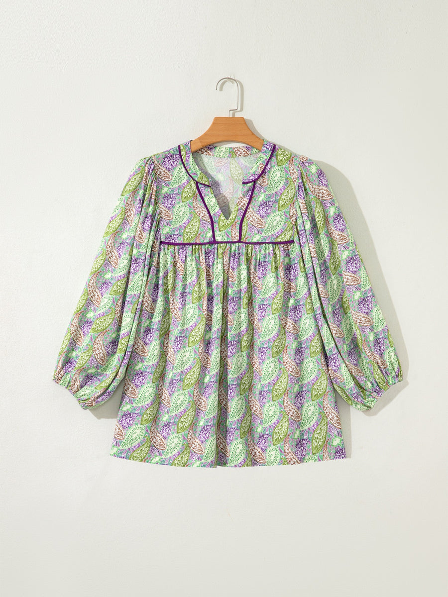 Paisley print blouse with puff sleeves and purple trim.