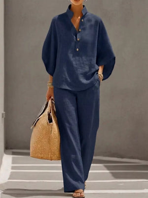 Dark blue button-down loungewear set with wide sleeves and relaxed fit pants.