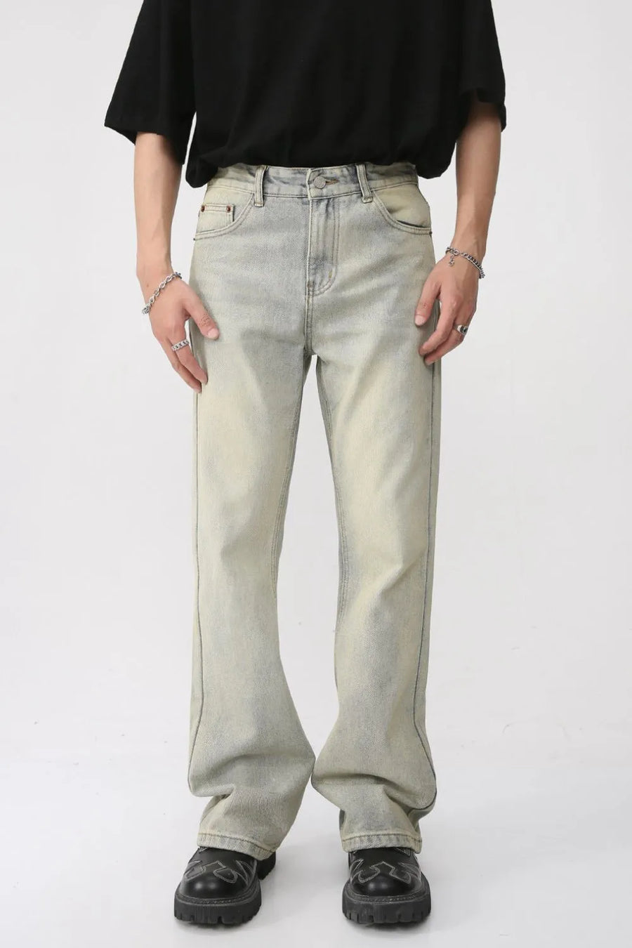 Vintage wash flare denim trousers in light blue with a relaxed fit and subtle fading.