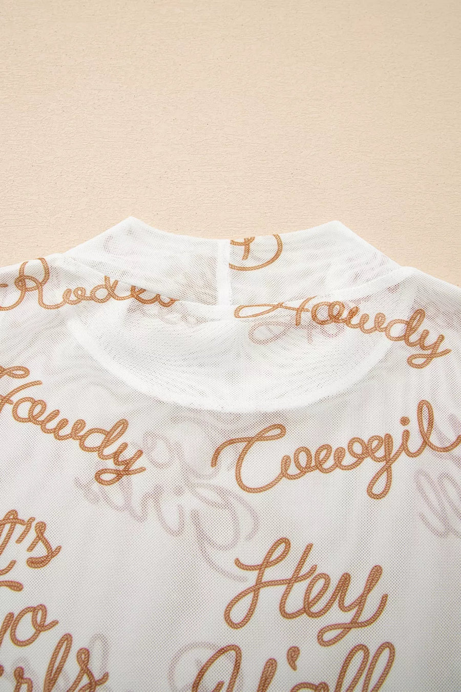 White sheer high-neck shirt with all-over "Howdy Hey Y'all" text print.