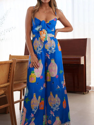 Blue tie-front wide-leg jumpsuit with architectural print and bow detail
