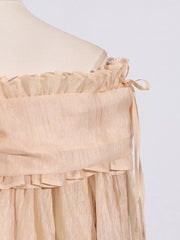 Romantic off-shoulder ruffled blouse in champagne color with tie details.
