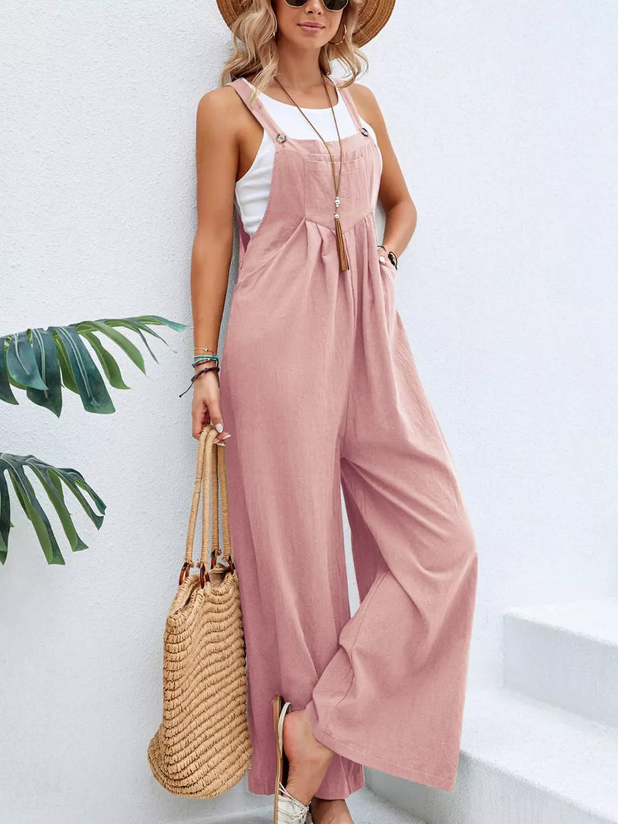 Pink wide-leg romper with pockets, adjustable straps, and button details.