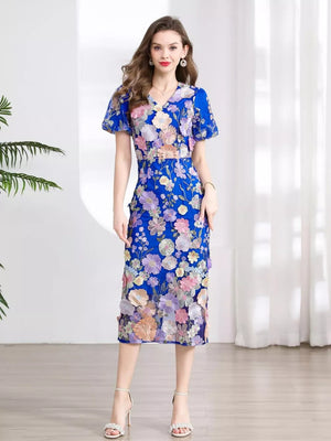Blue floral embroidered midi dress with V-neck and short sleeves.