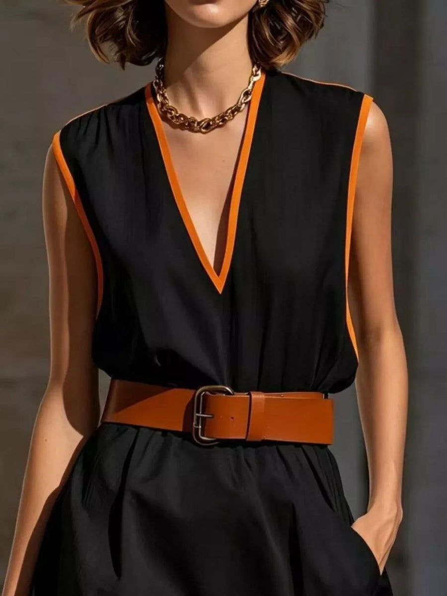 Black sleeveless v-neck dress with orange trim, cinched with a brown leather belt.