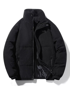 Black corduroy puffer jacket with high collar and zip closure.