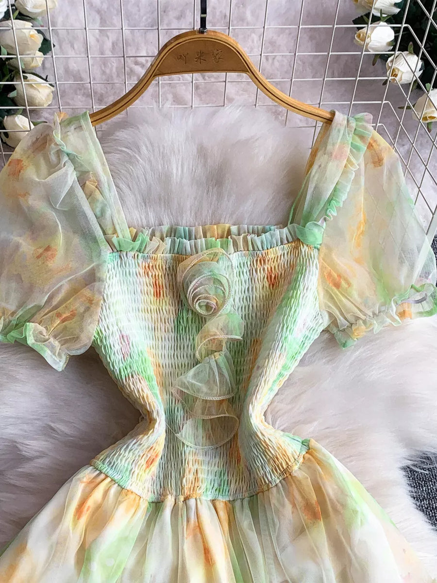 Floral tiered midi dress in light green with smocked bodice and puff sleeves.