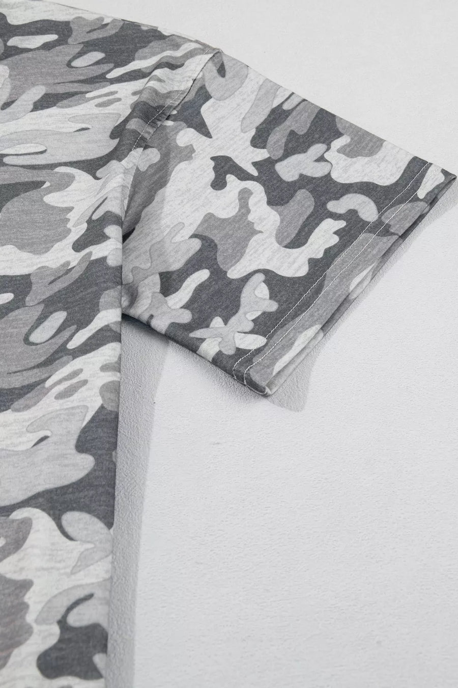 Gray camouflage relaxed fit V-neck tee with short sleeves.