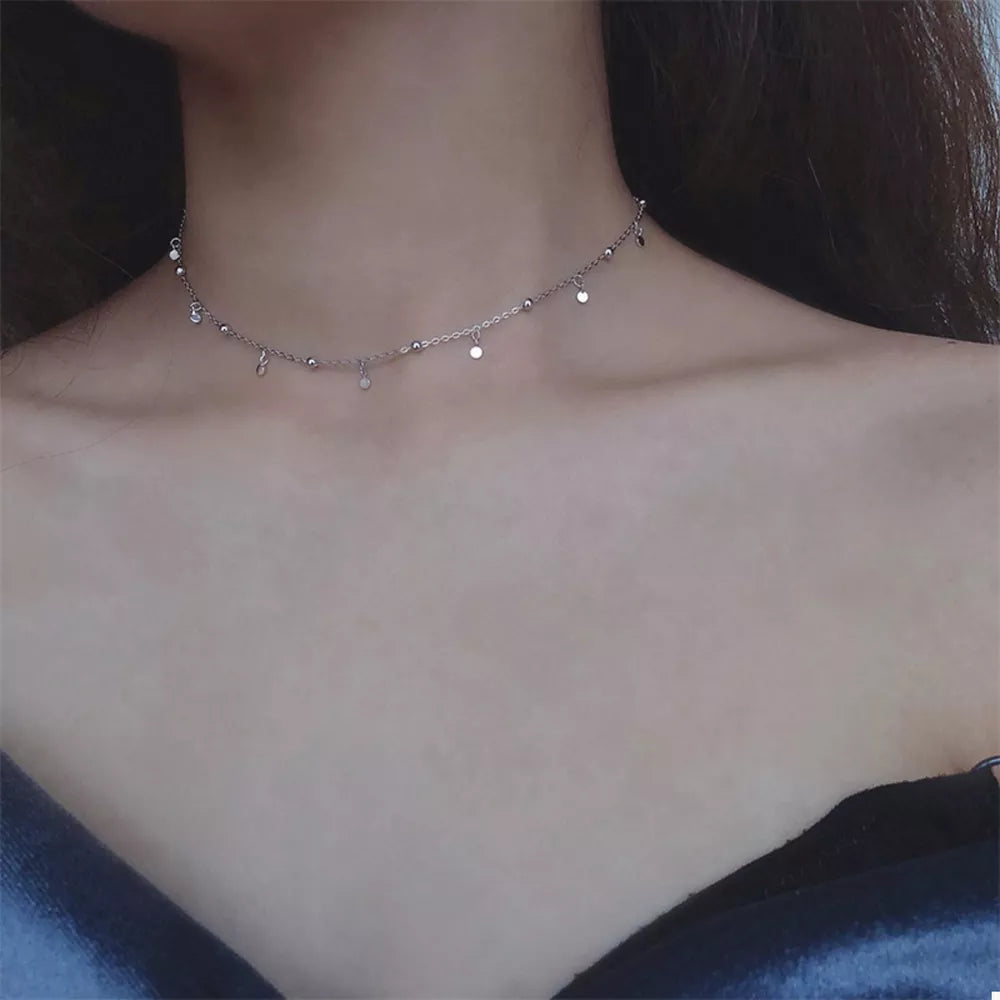 necklace in silver featuring disc charms and choker fit