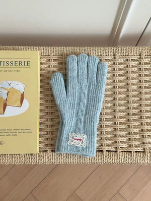 Blue cable knit acrylic gloves with decorative patch detail