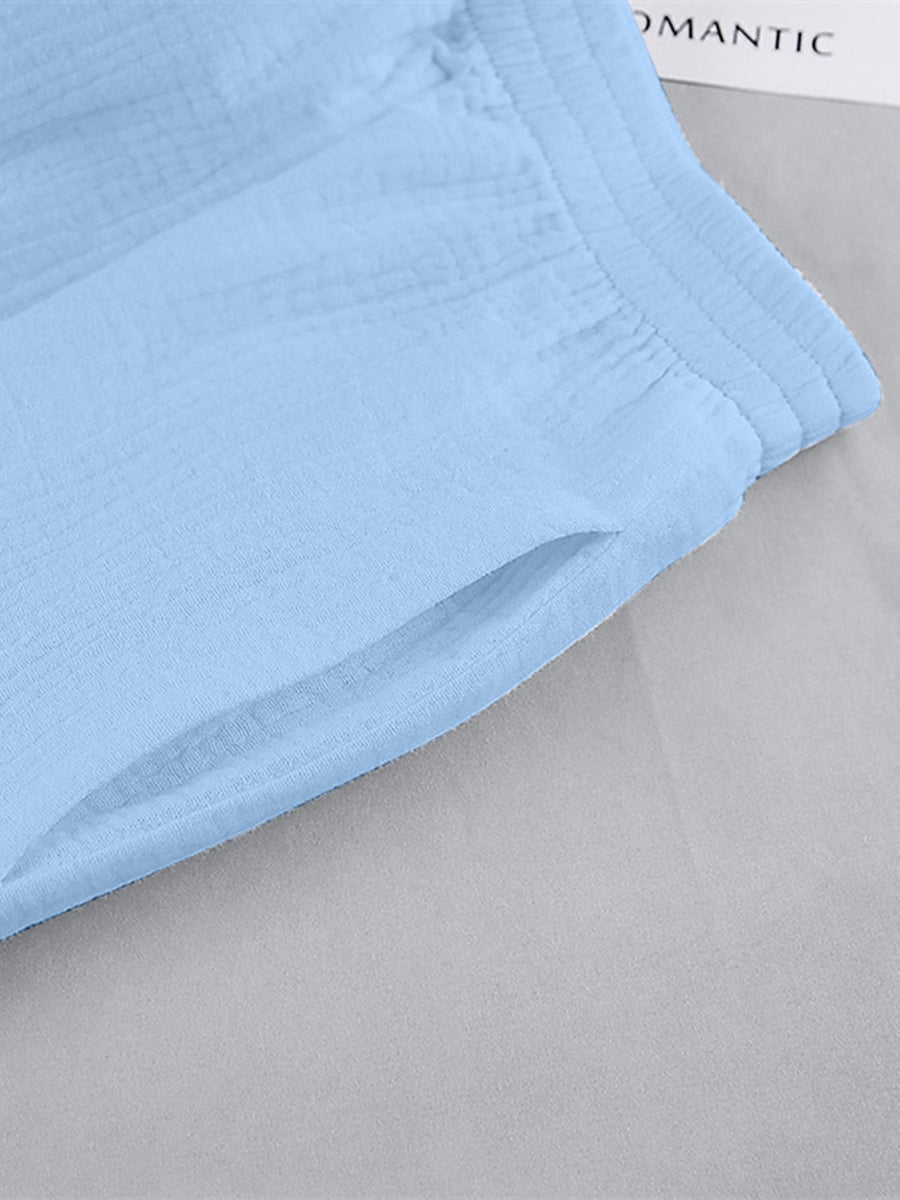 Light blue textured cotton lounge shorts with a pocket and elastic waistband