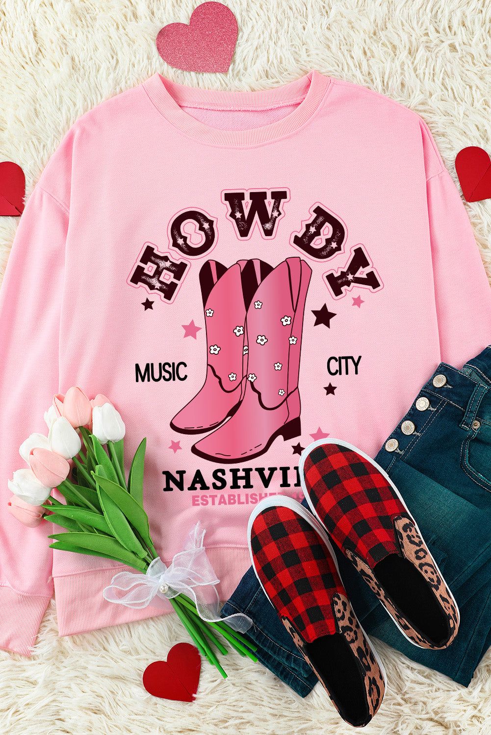 Blush pink crewneck sweatshirt with Nashville graphic, cowboy boots, and floral details.