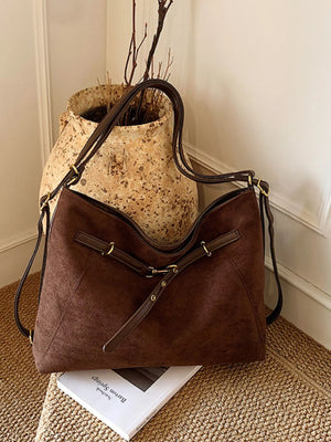 Chic brown suede large tote shopper bag with adjustable straps and gold hardware details.
