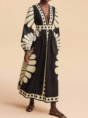 Maxi dress with deep V-neck, long sleeves, and bold black and cream geometric print.