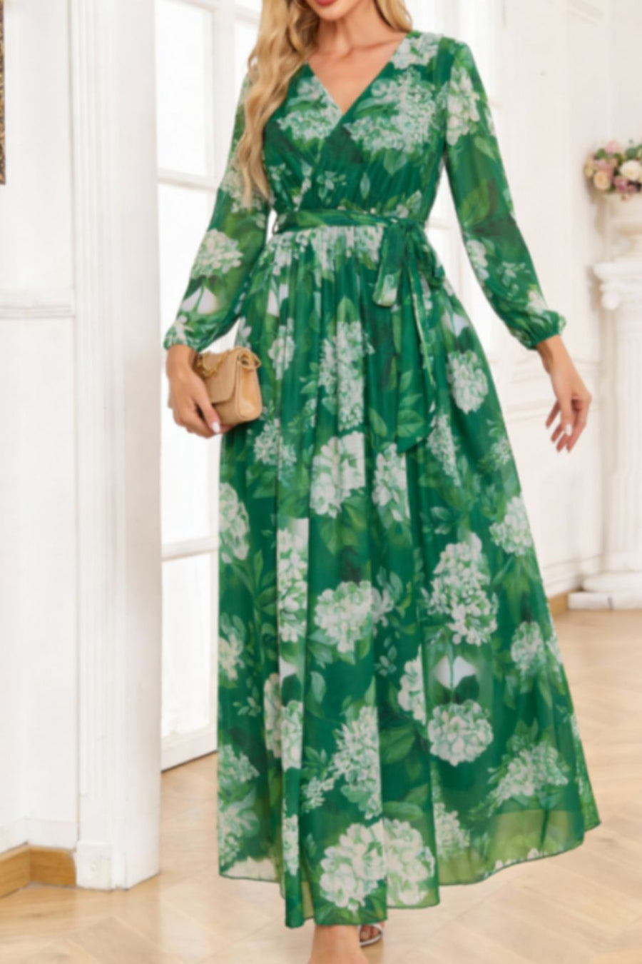 Green floral print maxi dress with V-neck, long sleeves, and tied waist.