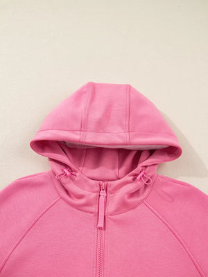 Dusty pink zip-up hoodie with drawstring hood and adjustable toggles.
