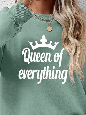 Sage green graphic sweatshirt with white Queen of Everything text and crown detail