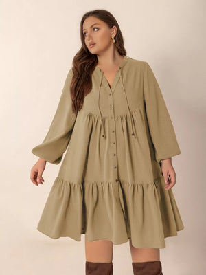 Olive green button-front tiered mini dress with tie-neck and balloon sleeves.