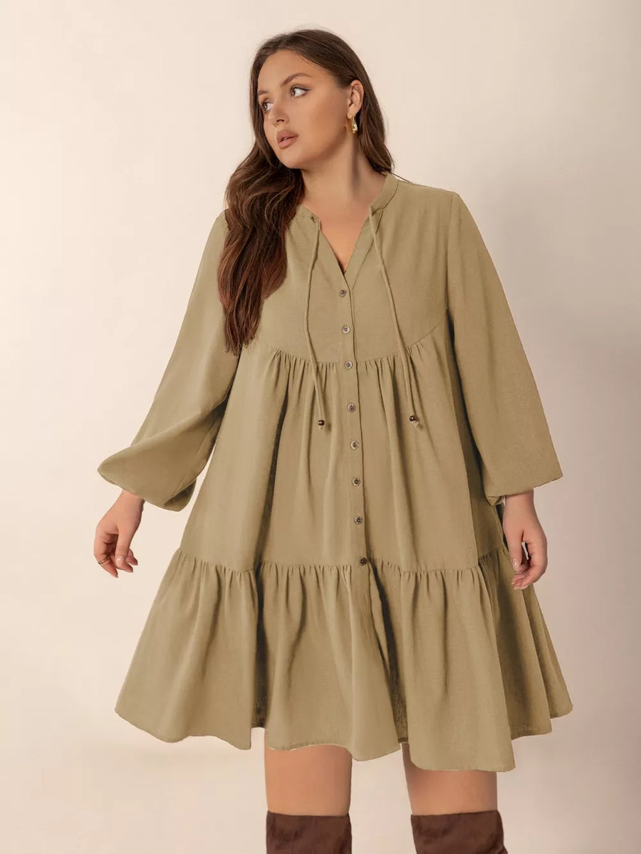 Olive green button-front tiered mini dress with tie-neck and balloon sleeves.