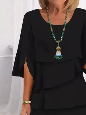 Black ruffled layered flutter sleeve dress with split sleeves and a tiered hem.