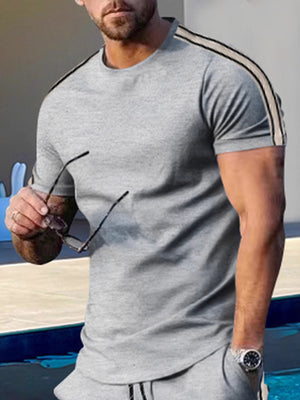 Men's light gray crew neck t-shirt with athletic stripes on the shoulders.