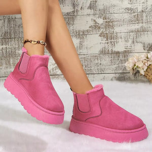 Hot pink suede round toe platform ankle boots with faux fur lining and elastic side panels.