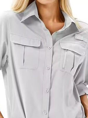 Light Gray roll-up sleeve button up shirt with two chest pockets, one with a zipper detail.