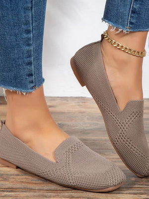 Beige knit ballet flats with a pointed toe and subtle diamond pattern.