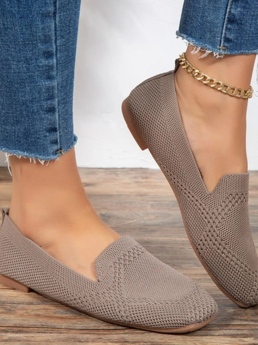 Beige knit ballet flats with a pointed toe and subtle diamond pattern.