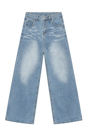 Oversized denim palazzo jeans in medium wash with subtle fading and wide legs.