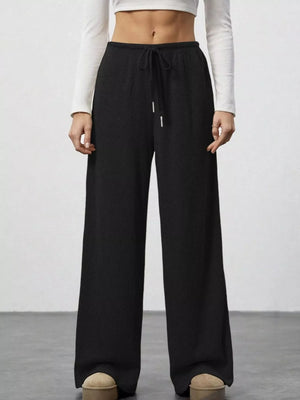 Black ribbed wide-leg pants with drawstring waist and white tips.