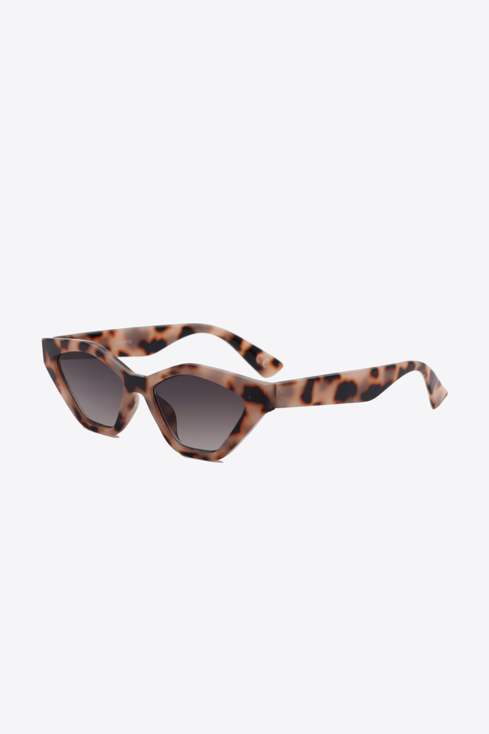 Geometric cat-eye sunglasses in leopard print with dark gradient lenses.