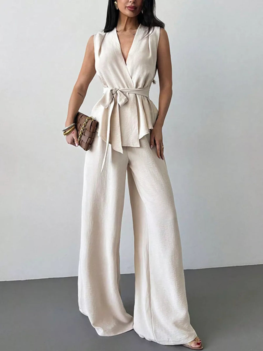 Sleeveless wrap top with tie waist and wide-leg pants set in cream polyester.