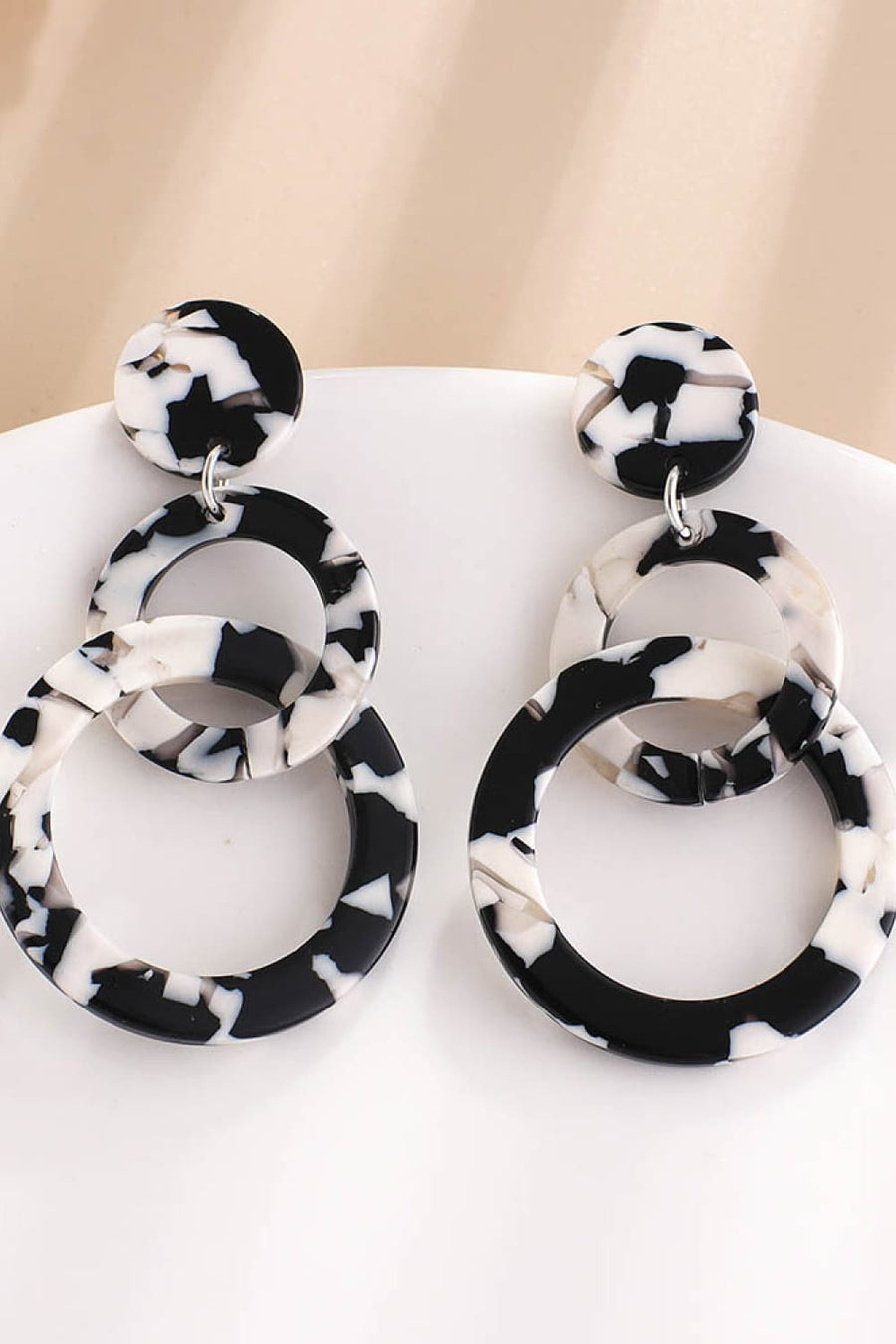 Black and white marbled hoop earrings with circular studs