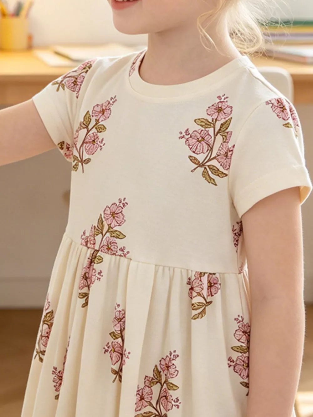 Charming floral cotton dress for toddlers in beige with pink floral print.