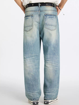 Men's relaxed wide-leg jeans in blue denim with distressed details and a faded wash.