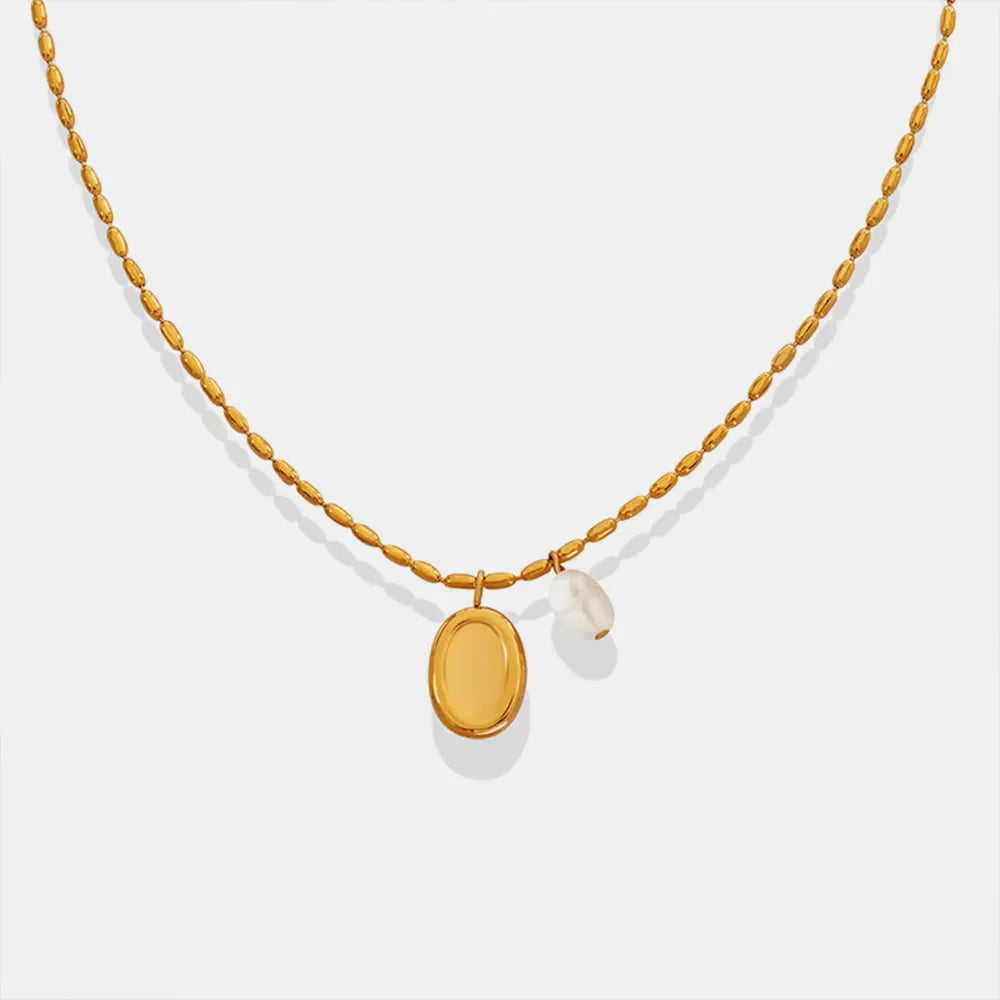 Gold oval medallion and pearl accent necklace with beaded chain