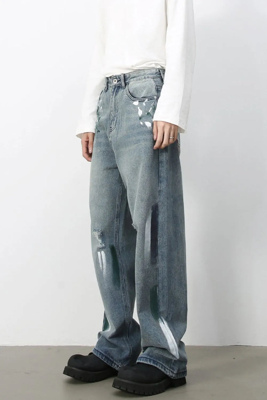 Ink-Blot Wide Leg Denim jeans in medium wash feature abstract paint splatters and distressed details.